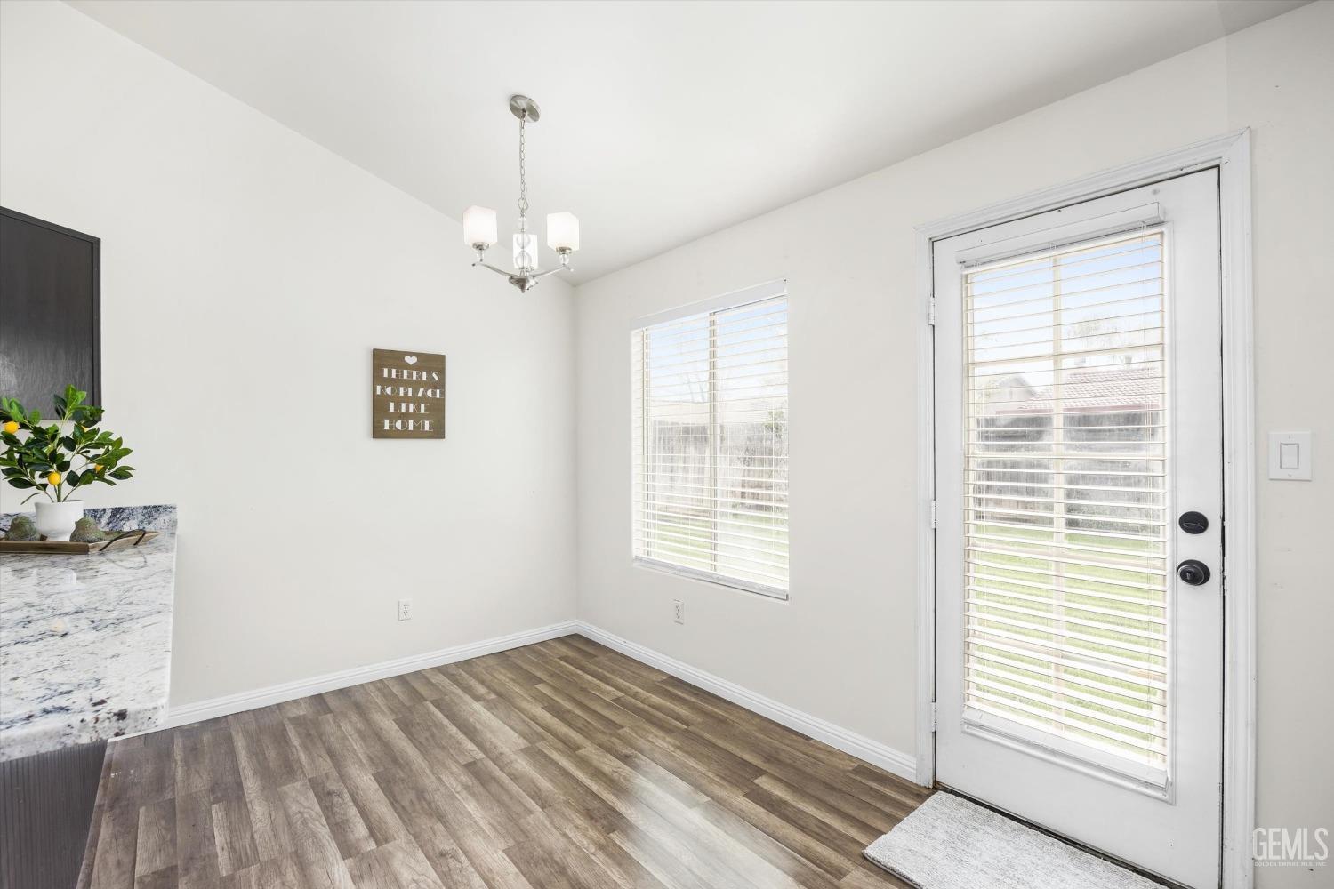 Undisclosed Address Bakersfield, CA 93307 - Photo 16 of 35 a view of an empty room with wooden floor and a window