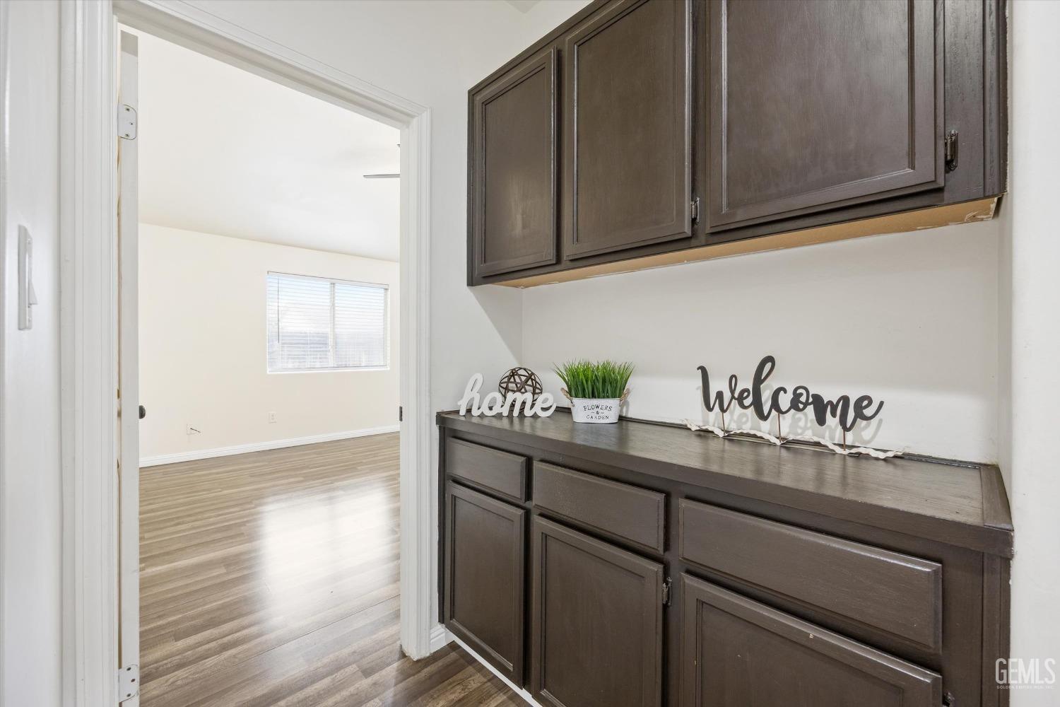 Undisclosed Address Bakersfield, CA 93307 - Photo 17 of 35 a kitchen with granite countertop a sink cabinets and wooden floor