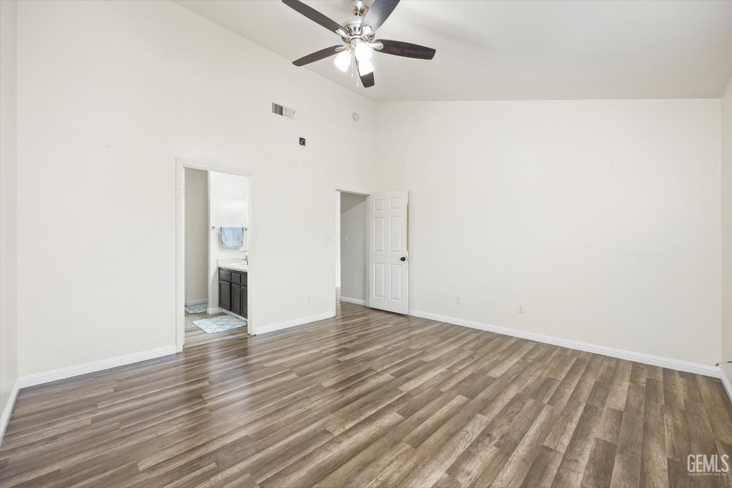Undisclosed Address Bakersfield, CA 93307 - Photo 18 of 35 an empty room with wooden floor a ceiling fan and closet