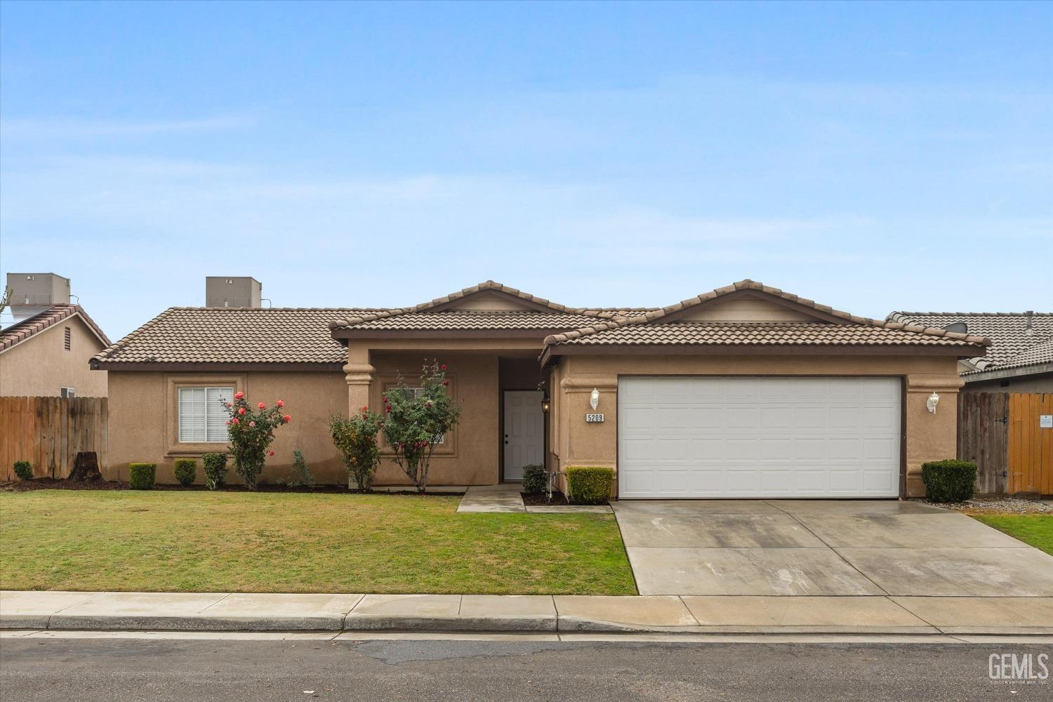 Undisclosed Address Bakersfield, CA 93307 - Photo 2 of 35 a front view of a house with garden