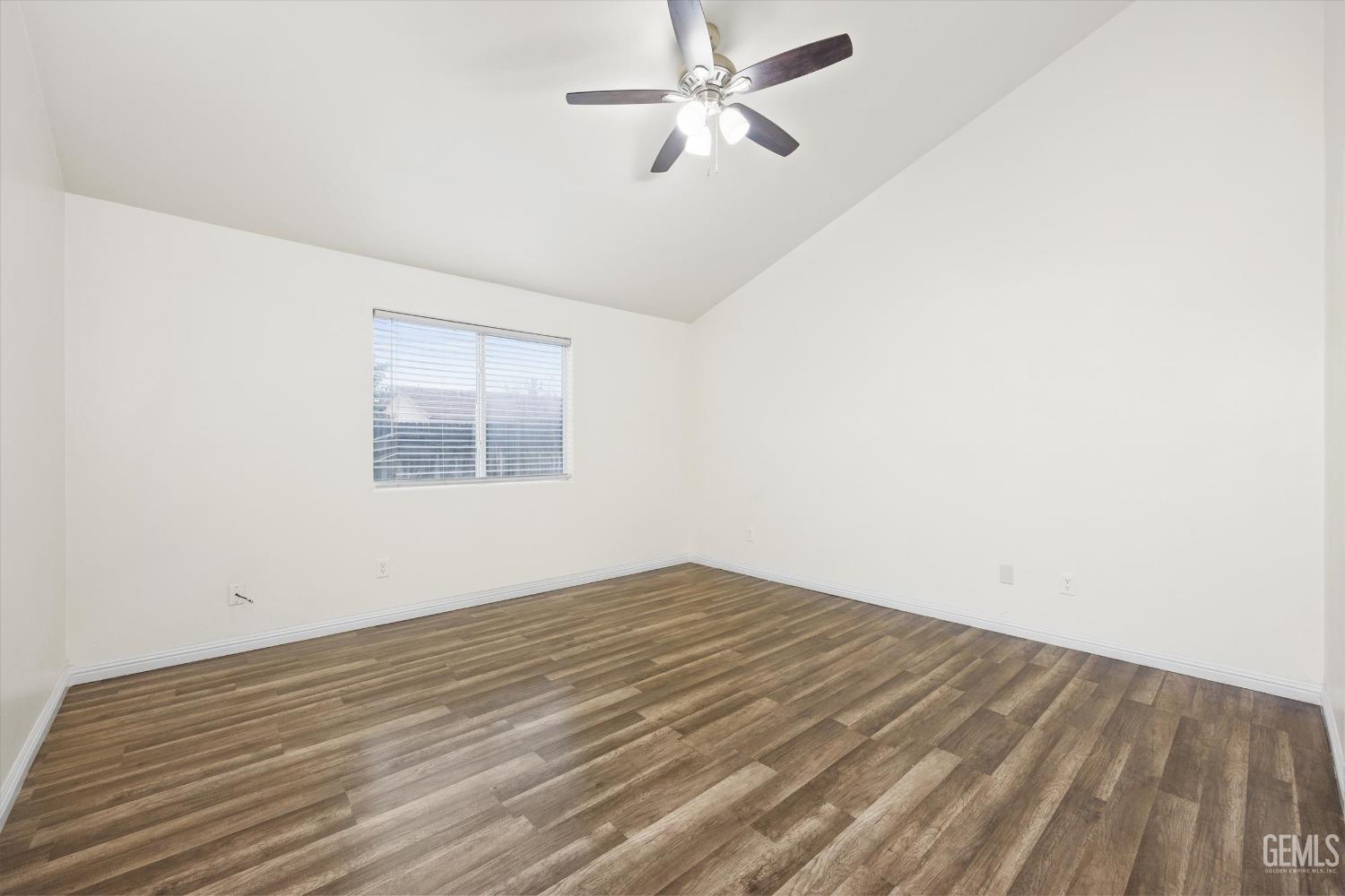 Undisclosed Address Bakersfield, CA 93307 - Photo 26 of 35 a view of empty room with wooden floor and fan