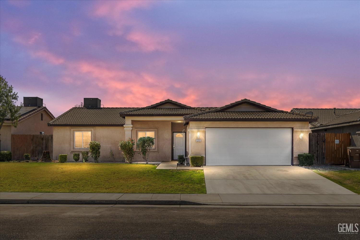 Undisclosed Address Bakersfield, CA 93307 - Photo 4 of 35 a front view of a house with a garden and yard
