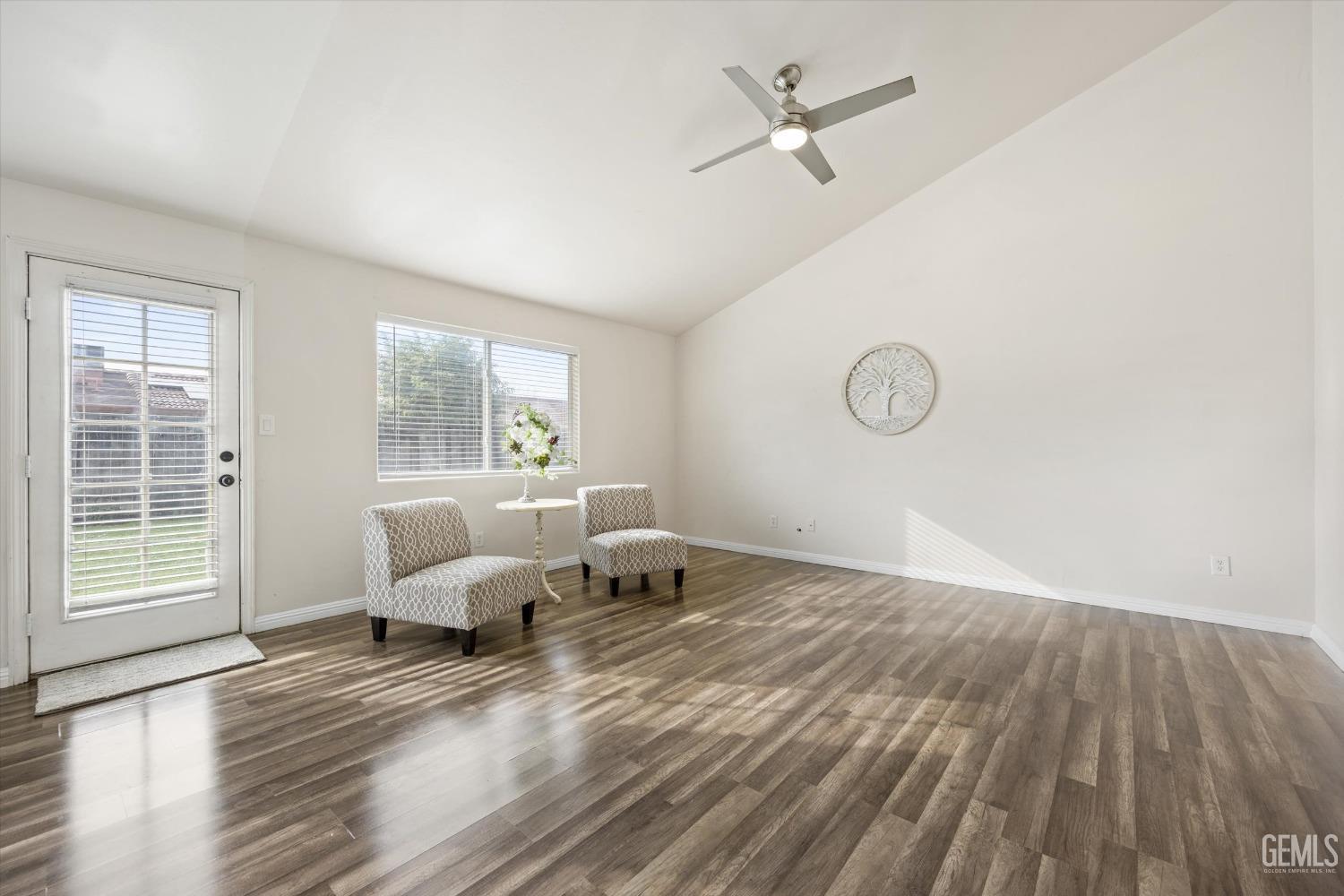 Undisclosed Address Bakersfield, CA 93307 - Photo 7 of 35 a living room with furniture and wooden floor