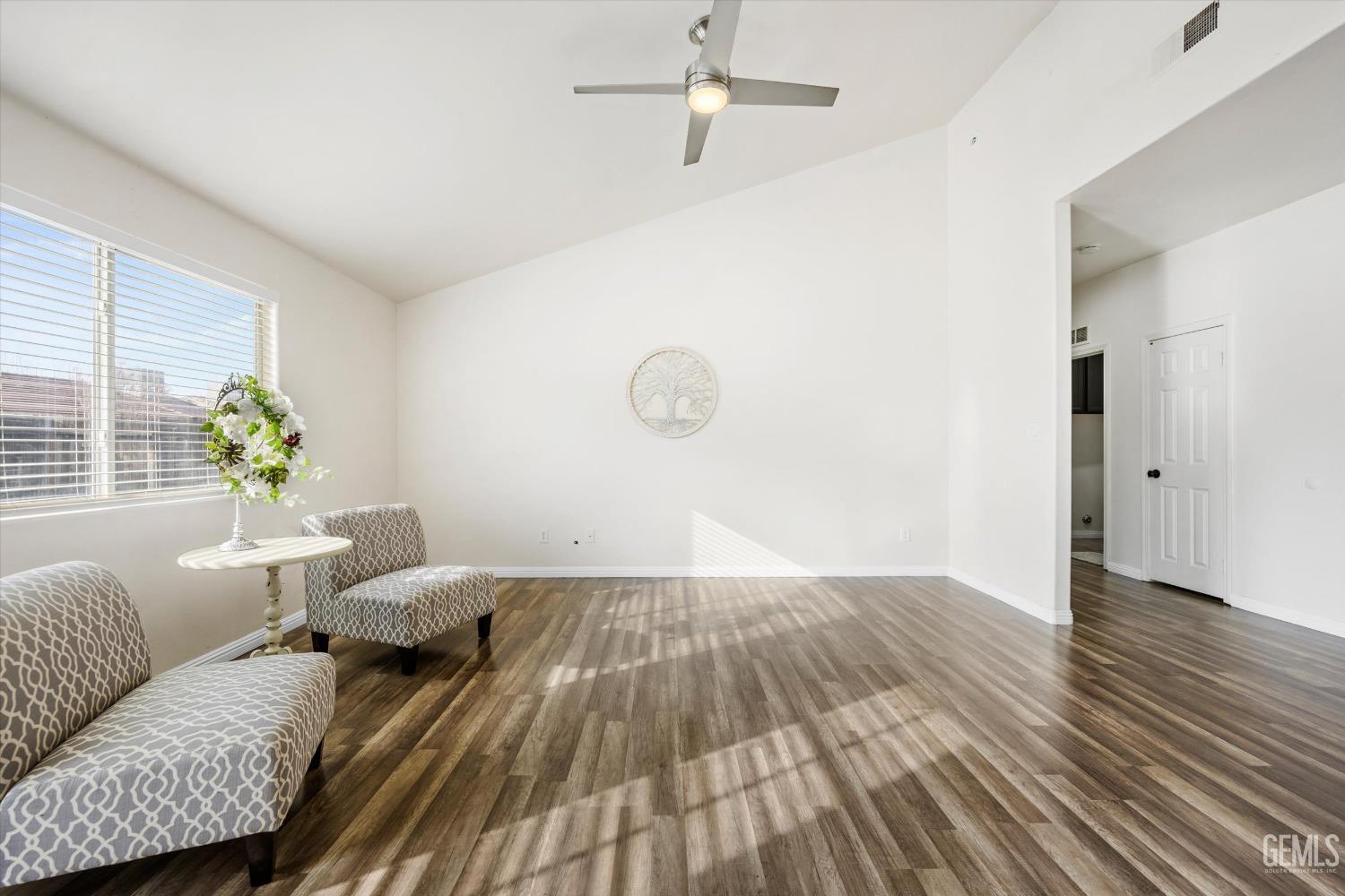 Undisclosed Address Bakersfield, CA 93307 - Photo 8 of 35 a living room with furniture and wooden floor
