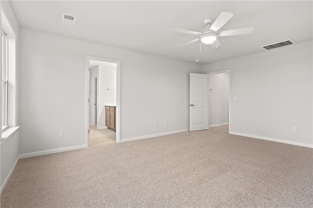 631 Sweetspire Trail, Unit 148 Seneca, SC 29678 - Photo 16 of 36 A quiet bedroom retreat with a practical ceiling fan, perfect for unwinding.