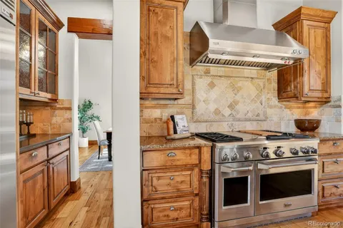 a kitchen with stainless steel appliances granite countertop a stove and a refrigerator