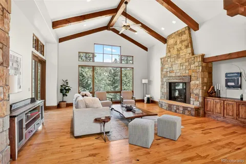 a living room with furniture large window and flat screen tv