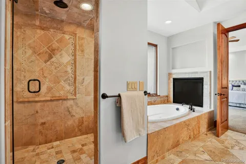a bathroom with a tub sink and mirror