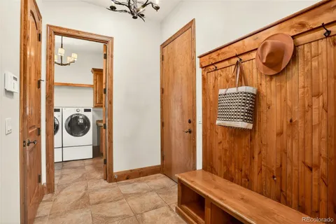a view of a hallway with a door and a mirror