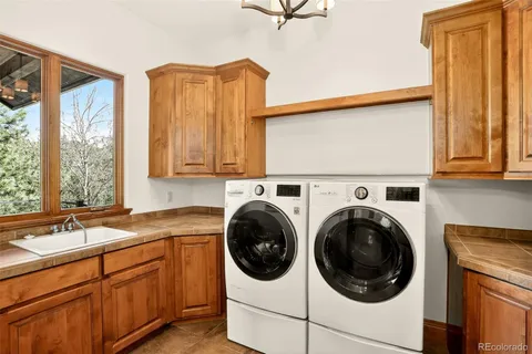 a utility room with sink dryer and washer