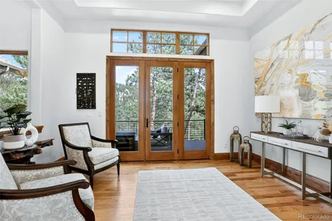 a living room with furniture and large windows