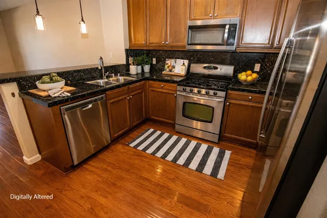 a view of patio with couches and a potted plant on a table