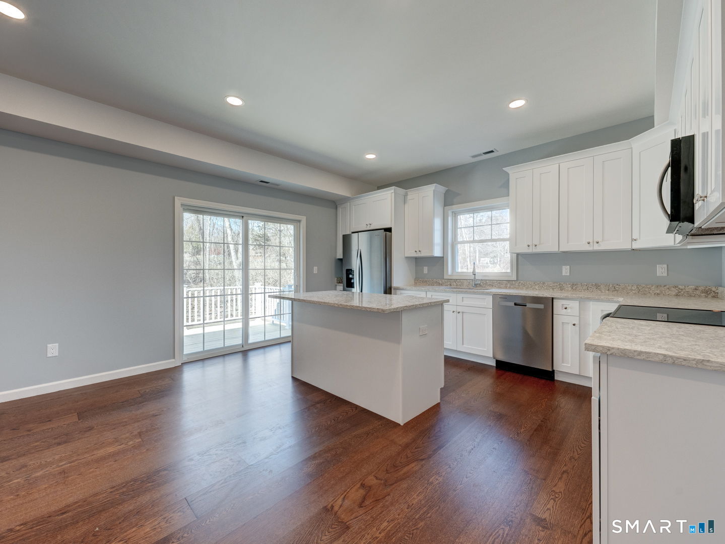 28 Goodell Road Stafford, CT 06076 - Photo 11 of 40 a kitchen with wooden floors and white appliances