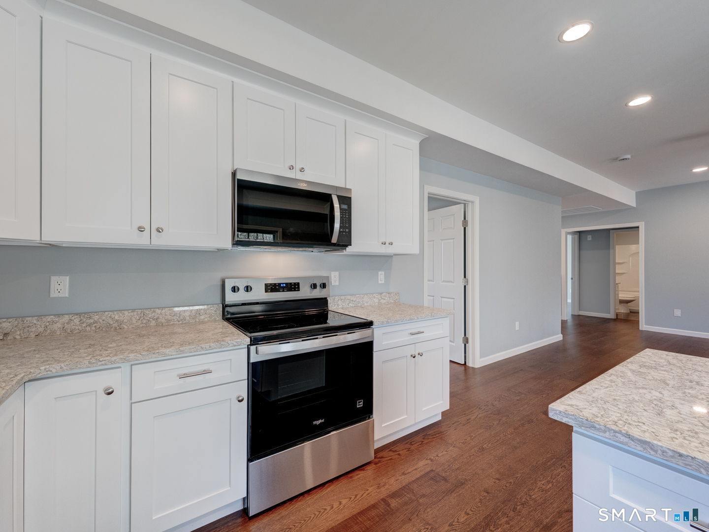 28 Goodell Road Stafford, CT 06076 - Photo 16 of 40 a kitchen with stainless steel appliances granite countertop a stove a sink and a microwave