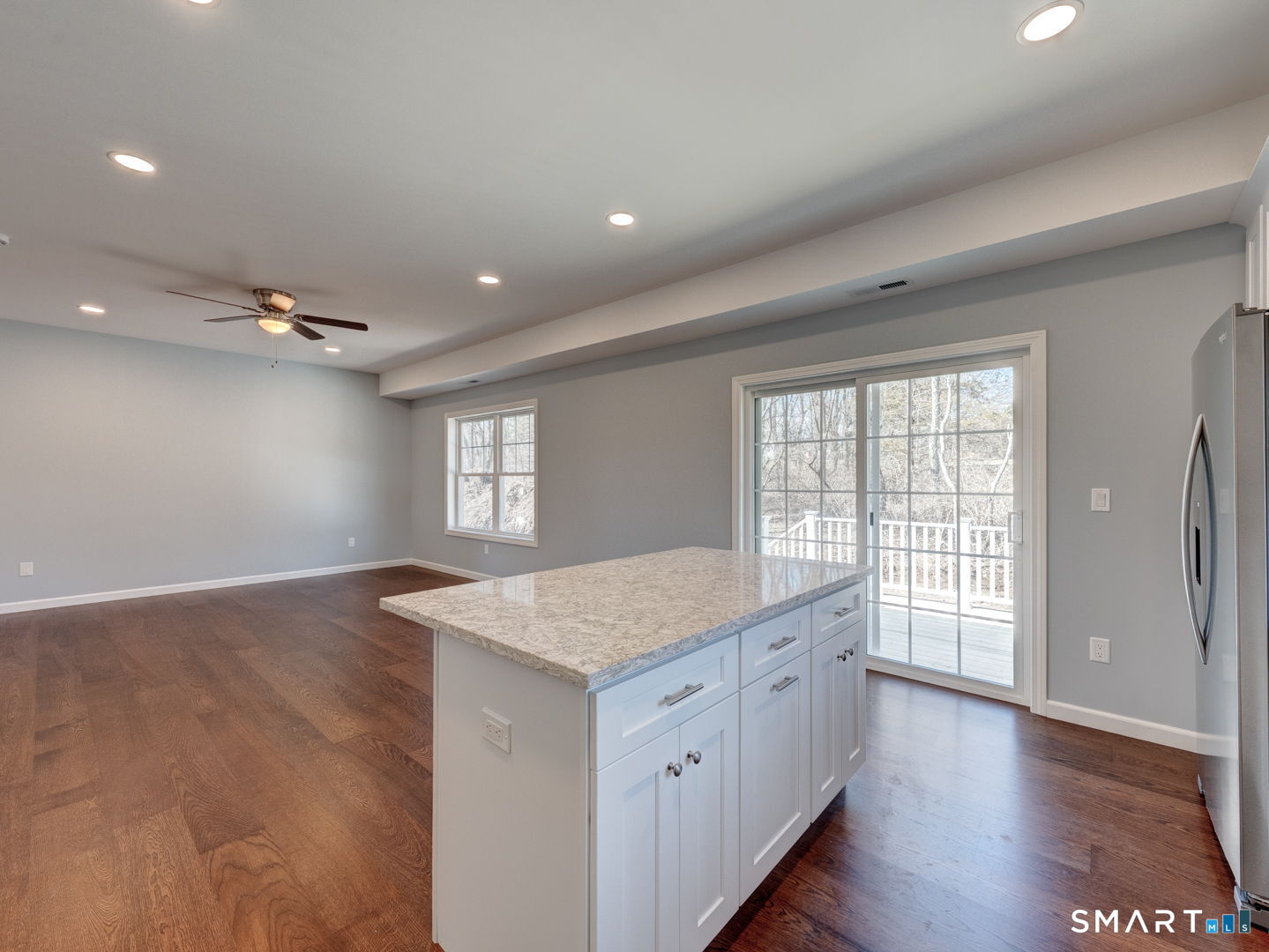28 Goodell Road Stafford, CT 06076 - Photo 17 of 40 a hall with kitchen island a stove a wooden floor and a large window