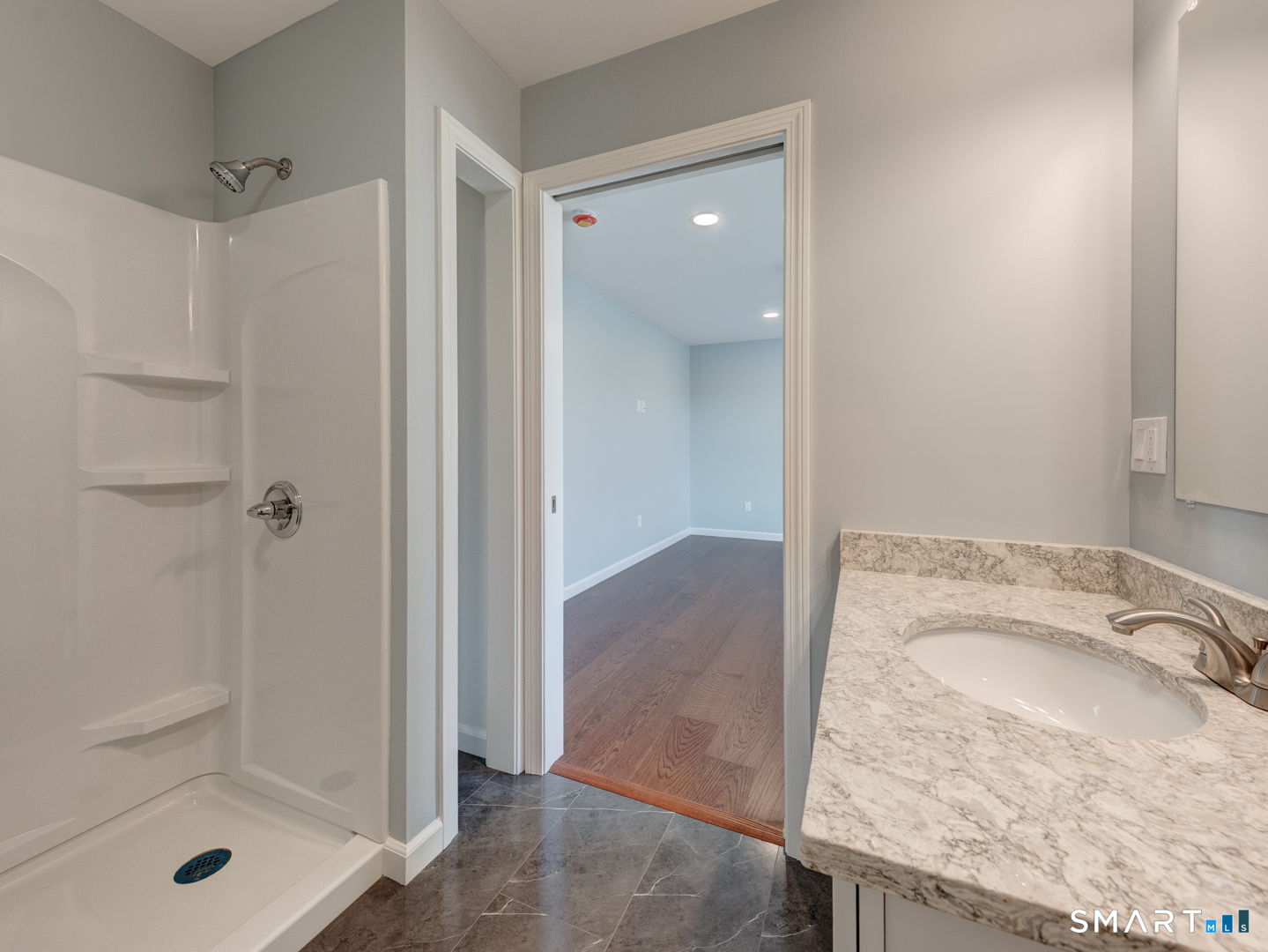 28 Goodell Road Stafford, CT 06076 - Photo 26 of 40 a bathroom with a granite countertop sink a mirror and shower
