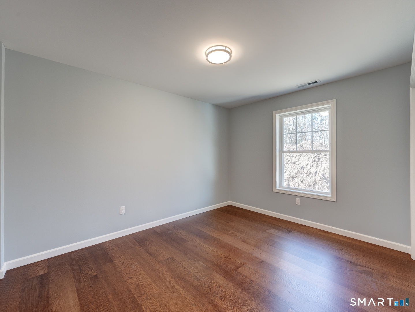 28 Goodell Road Stafford, CT 06076 - Photo 31 of 40 an empty room with wooden floor and windows