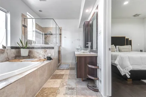 a bathroom with a tub sink and mirror