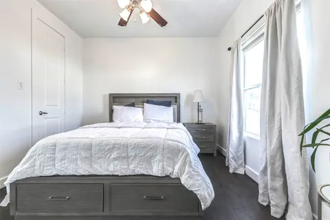 a bedroom with a bed and a window