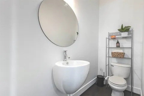 a white toilet sitting next to a bathroom sink