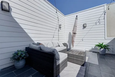 a view of a chairs in back side of the house