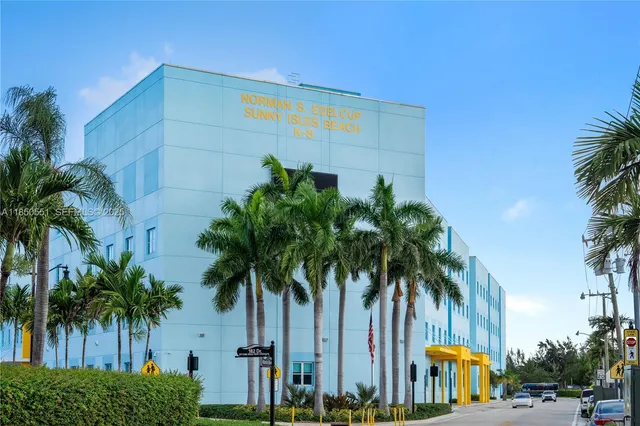 a palm tree sitting in front of a building