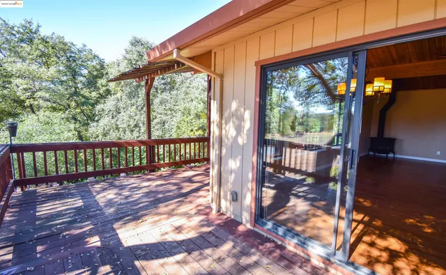 a view of a porch with wooden floor and outdoor space