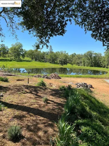 a view of a lake with houses in the back