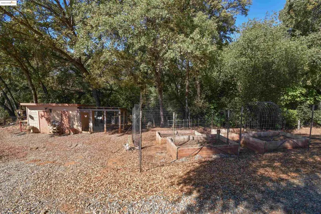 a backyard of a house with table and chairs