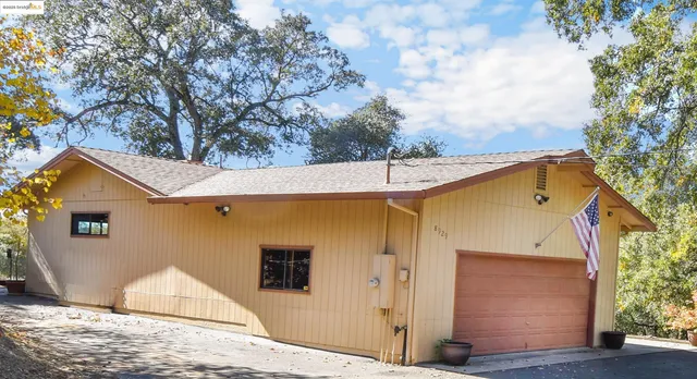 a view of a house with a tree
