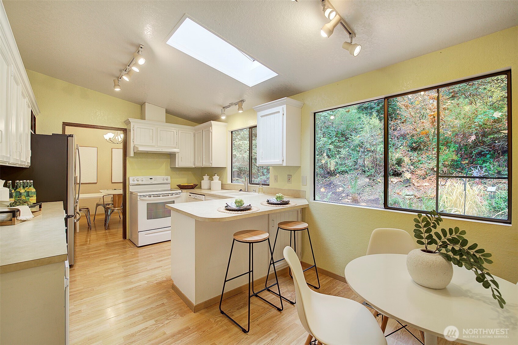 22710 2nd Avenue Southeast Bothell, WA 98021 - Photo 10 of 34 a large kitchen with kitchen island a large window cabinets and stainless steel appliances