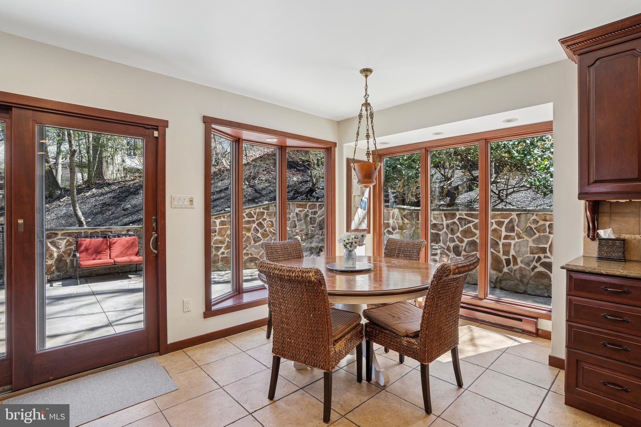 1343 Centennial Road Penn Valley, PA 19072 - Photo 11 of 36 a dining room with furniture large windows and a chandelier