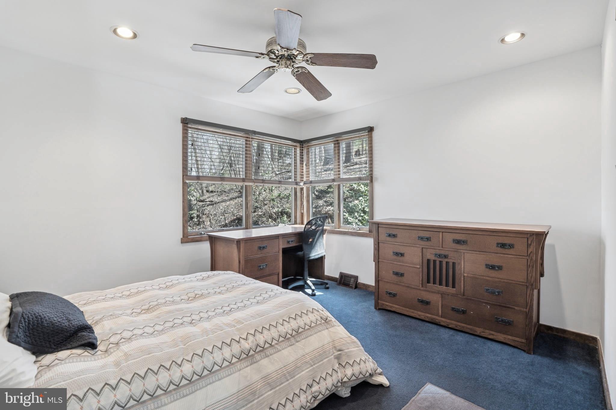 1343 Centennial Road Penn Valley, PA 19072 - Photo 28 of 36 a bedroom with a bed and a chandelier