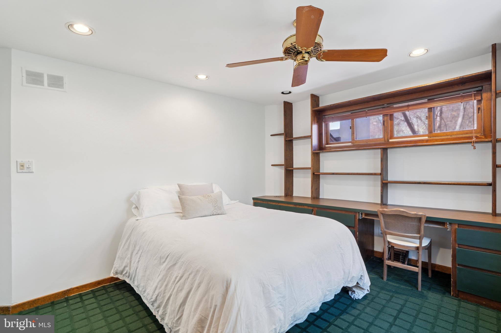 1343 Centennial Road Penn Valley, PA 19072 - Photo 29 of 36 a bedroom with a bed and a chandelier
