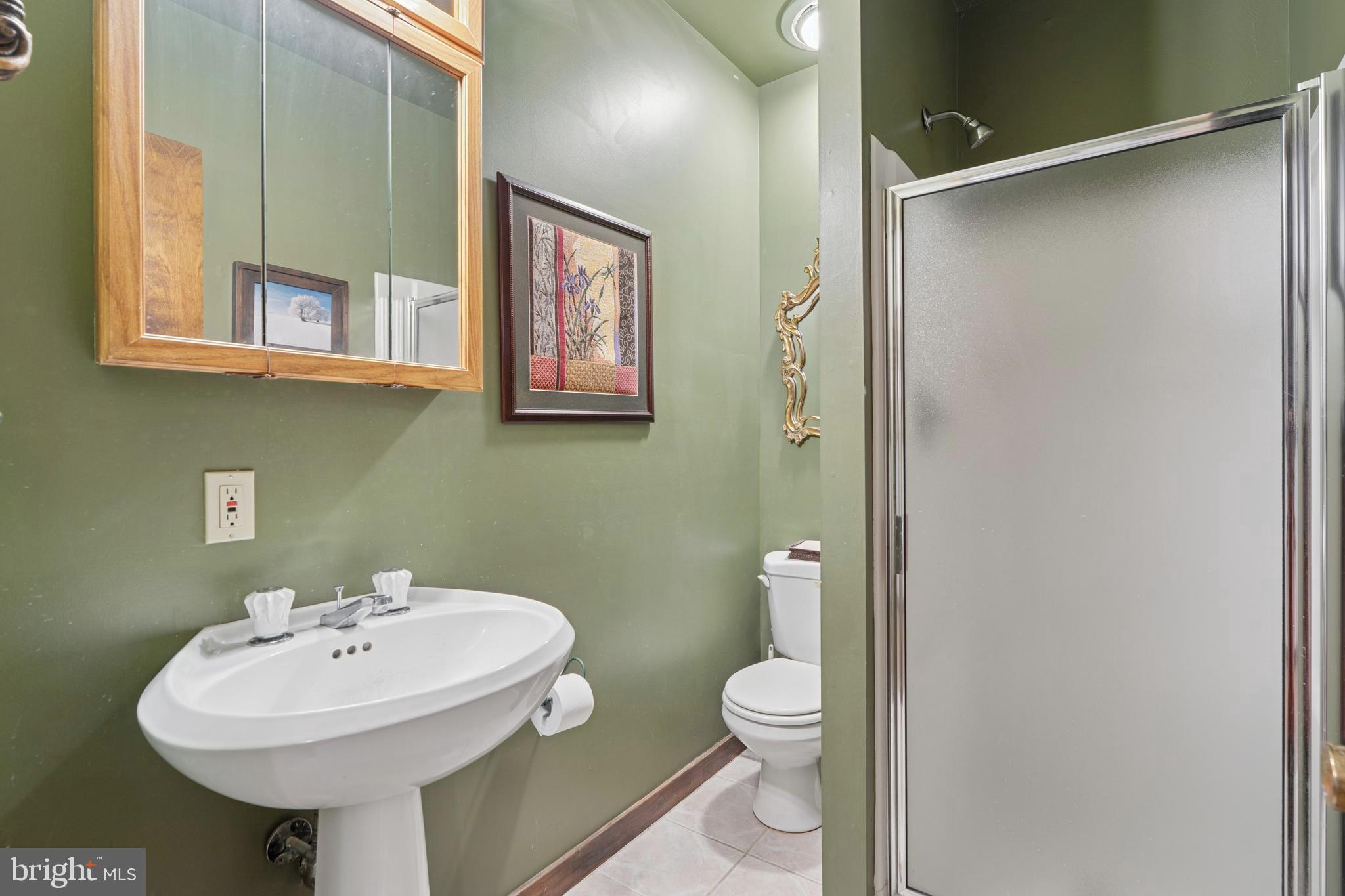 1343 Centennial Road Penn Valley, PA 19072 - Photo 32 of 36 a bathroom with a sink toilet and a mirror
