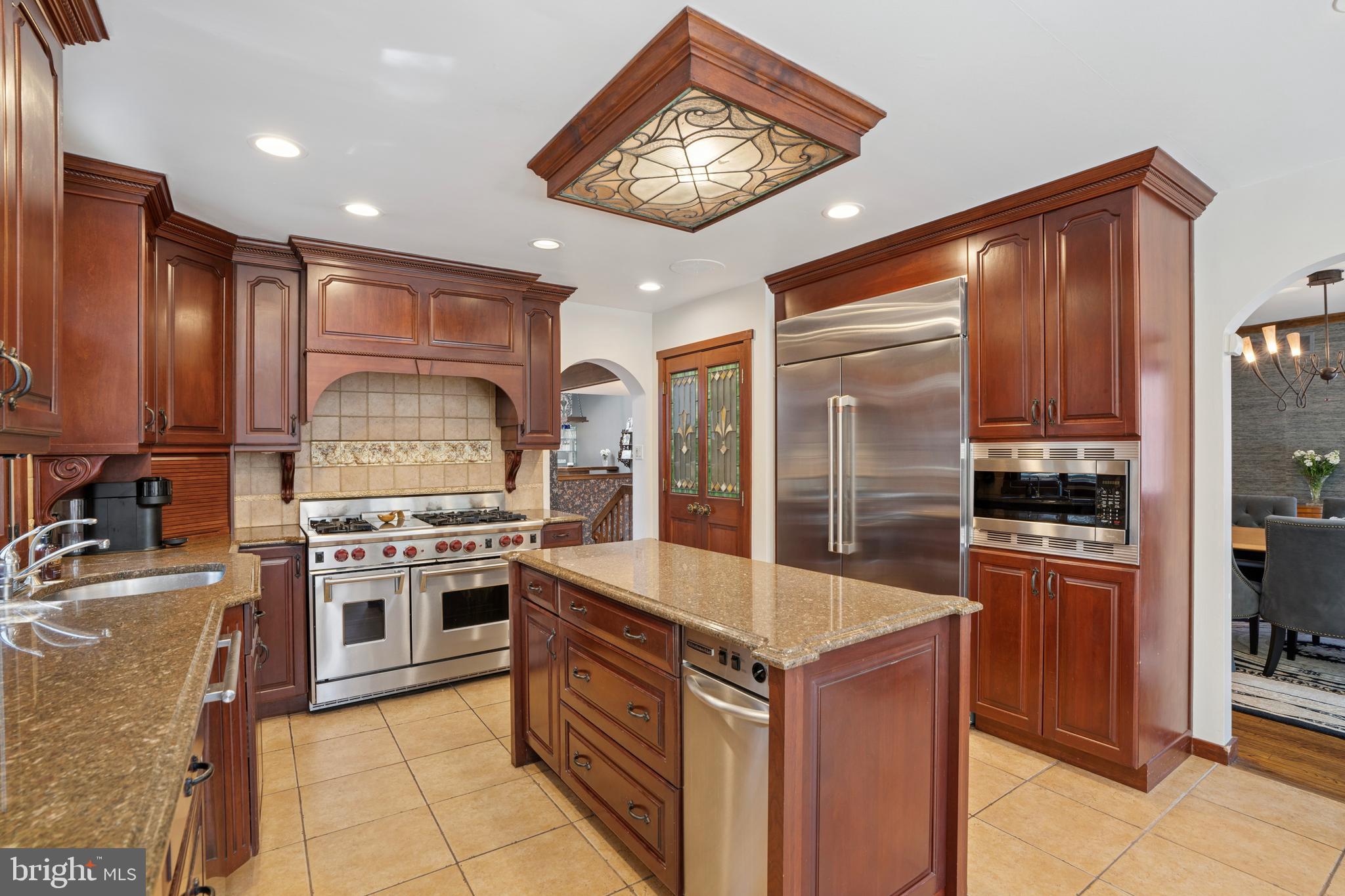 1343 Centennial Road Penn Valley, PA 19072 - Photo 10 of 36 a kitchen with stainless steel appliances granite countertop a stove top oven a sink and a refrigerator