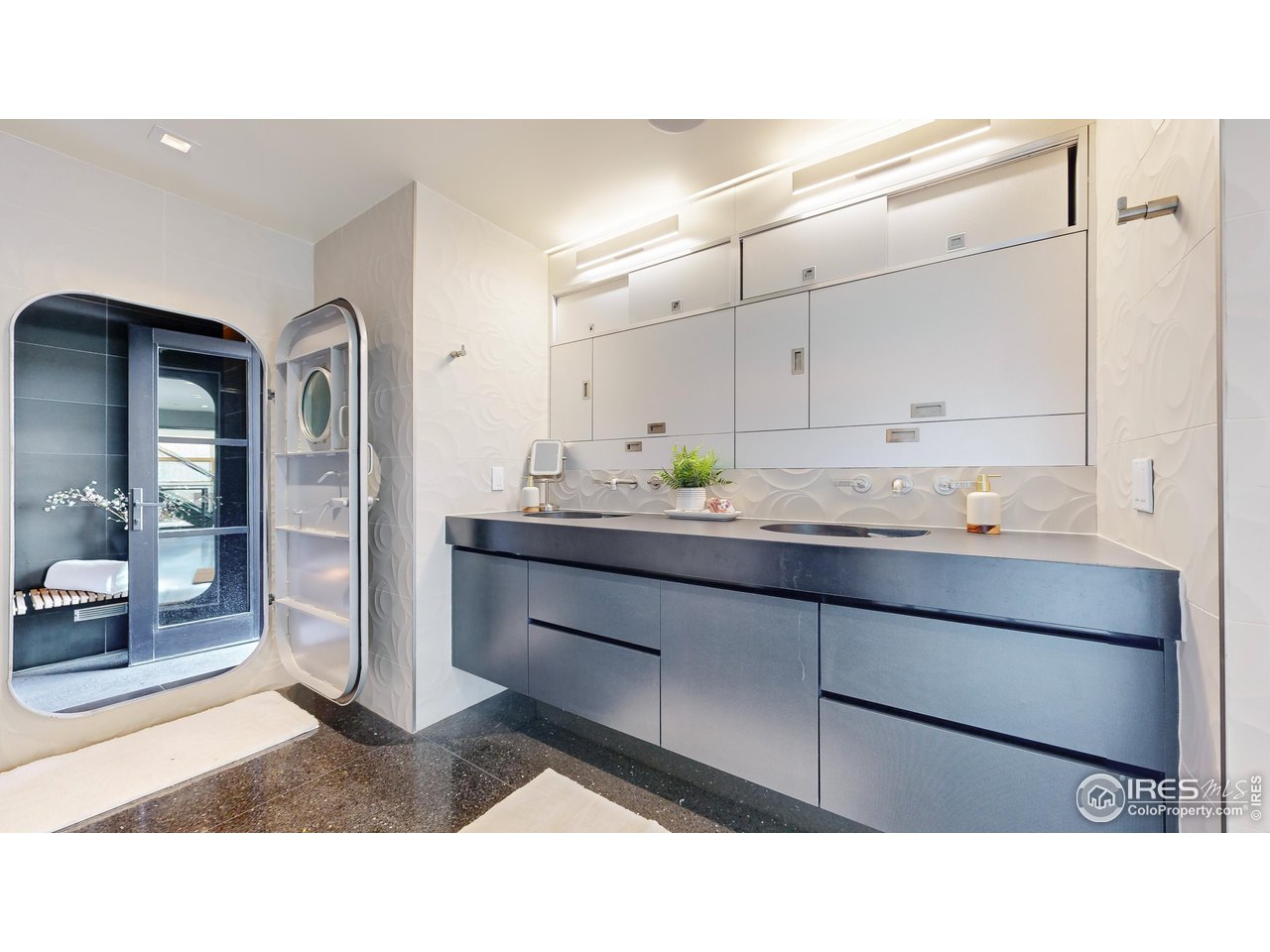 987 Lost Angel Road Boulder, CO 80302 - Photo 17 of 40 a bathroom with a sink a mirror and a shower