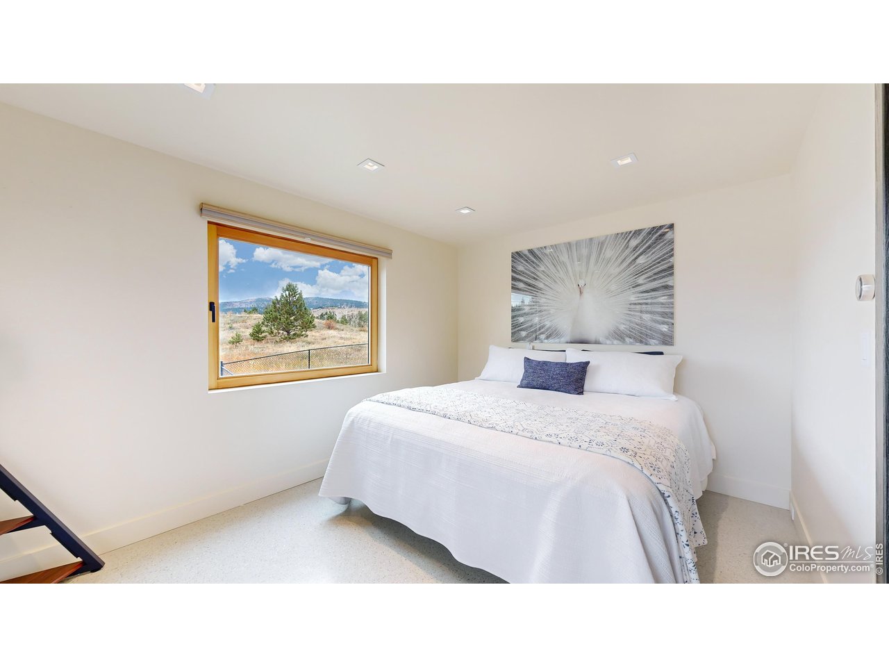 987 Lost Angel Road Boulder, CO 80302 - Photo 18 of 40 a bedroom with a bed and painting on the wall