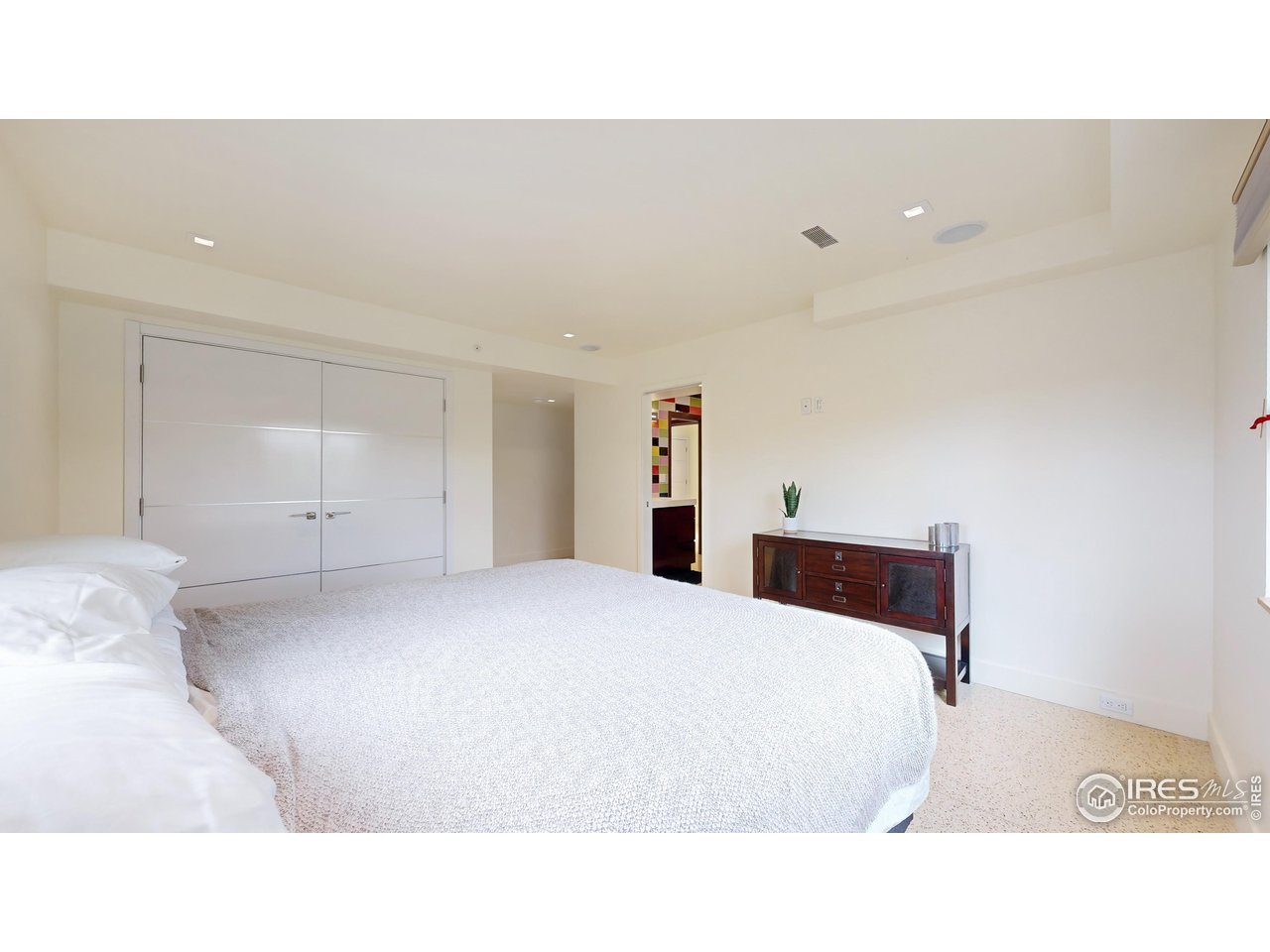 987 Lost Angel Road Boulder, CO 80302 - Photo 22 of 40 a bedroom with a bed and a night stand