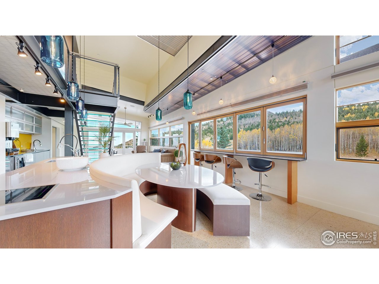 987 Lost Angel Road Boulder, CO 80302 - Photo 6 of 40 a living room with couches a dining table and chairs with outer view