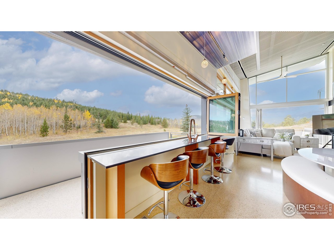 987 Lost Angel Road Boulder, CO 80302 - Photo 7 of 40 a living room with furniture a rug and a painting on the wall