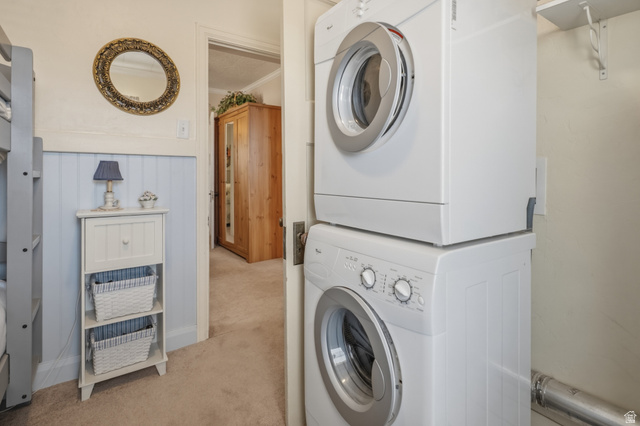 82 South 100 West Lyman, UT 84749 - Photo 19 of 27 Laundry area featuring light colored carpet, ornamental molding, stacked washing machine and dryer, and wainscoting