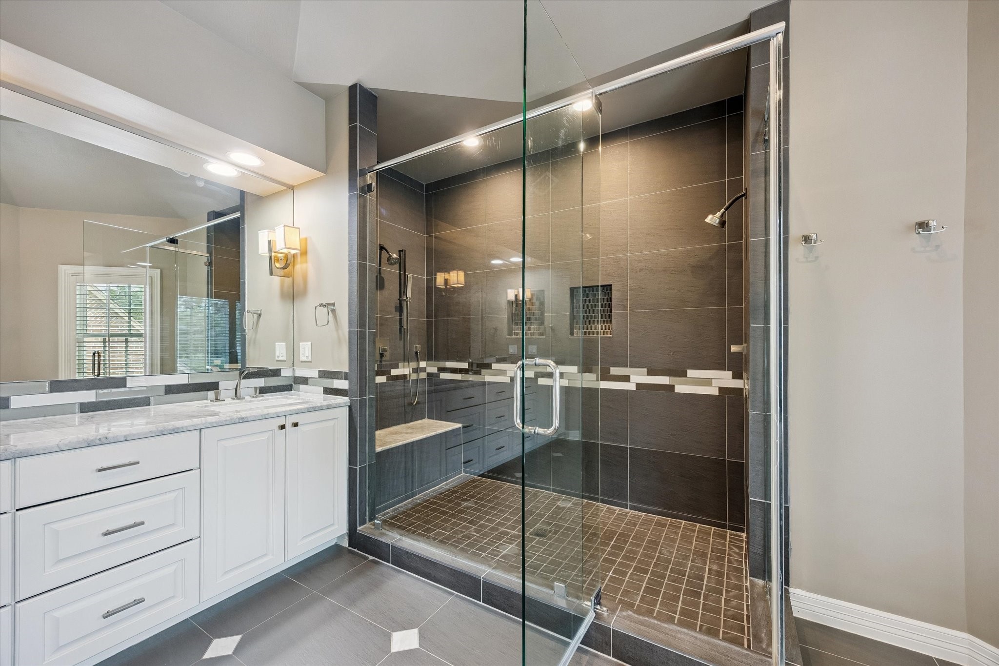 6358 Auden Street Houston, TX 77005 - Photo 25 of 50 a bathroom with a granite countertop sink mirror and shower
