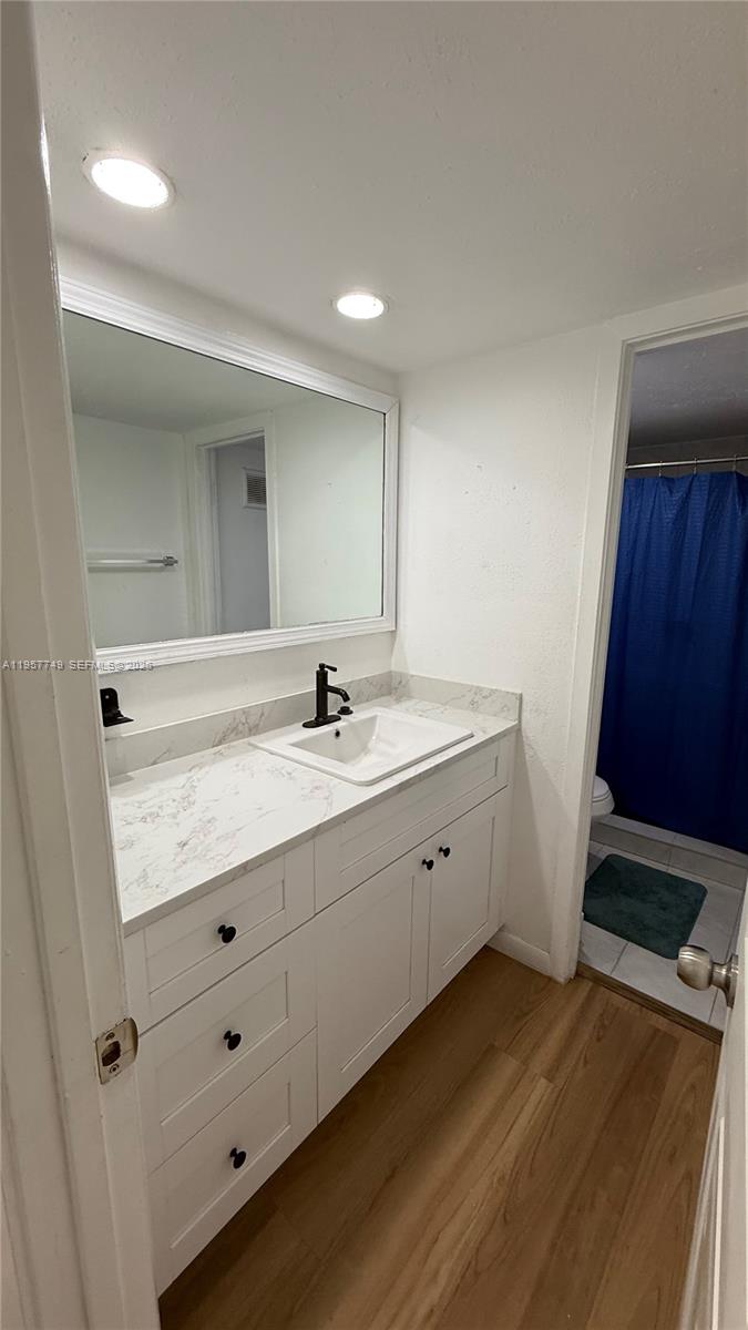 10400 Southwest 108th Avenue, Unit A202 Miami, FL 33176 - Photo 19 of 23 a bathroom with a double vanity sink and mirror