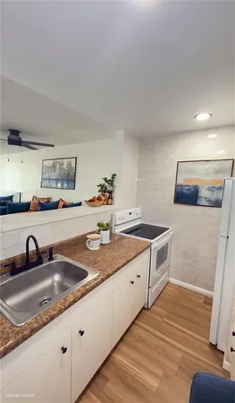 a kitchen with granite countertop a sink and a stove top oven