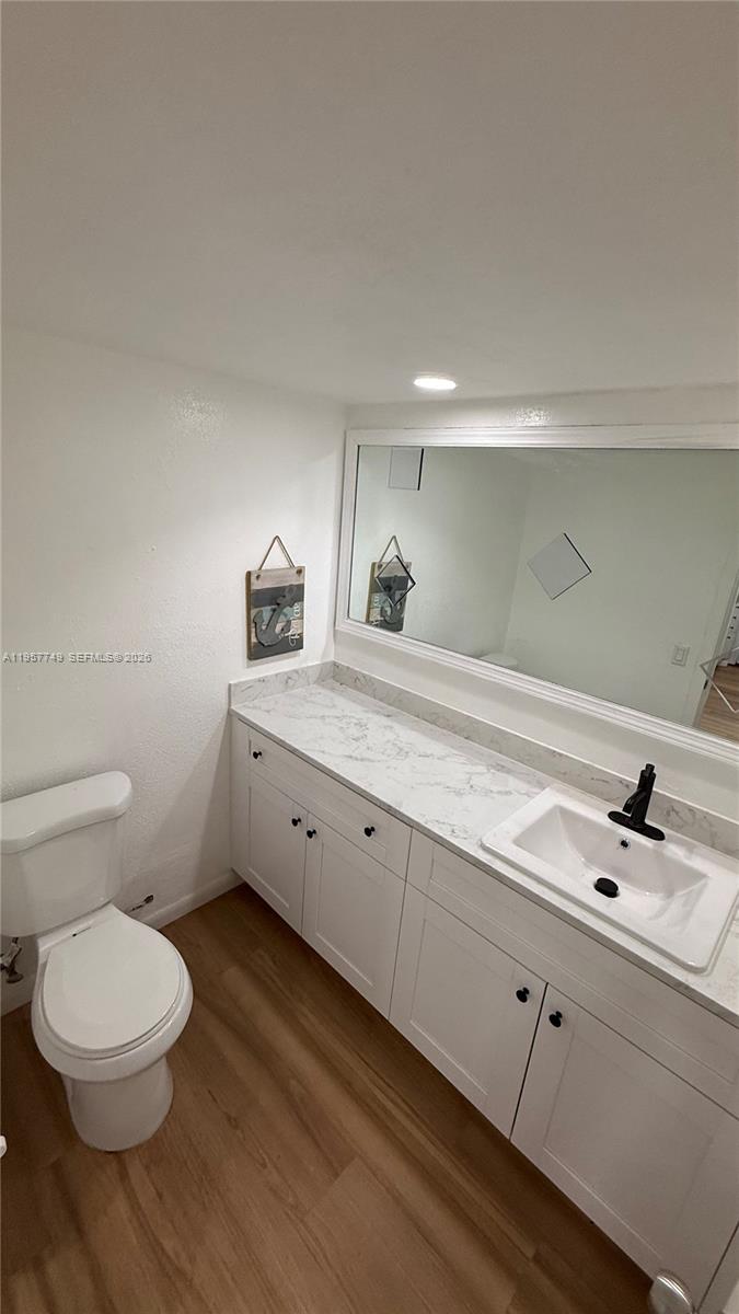 10400 Southwest 108th Avenue, Unit A202 Miami, FL 33176 - Photo 8 of 23 a bathroom with a toilet sink and mirror