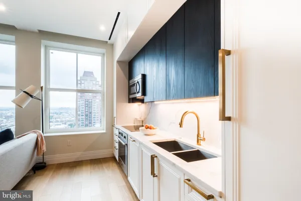 a kitchen with a sink a window and cabinets