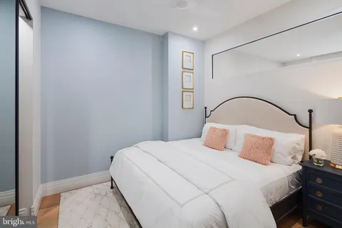 a bedroom with a bed and a mirror