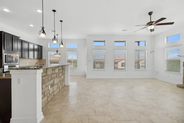 a kitchen with stainless steel appliances granite countertop a stove a sink and a refrigerator