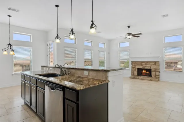 a kitchen with stainless steel appliances granite countertop a sink stove and cabinets